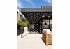 Modern home with Outdoor, Hardscapes, Side Yard, Shrubs, Walkways, Wood Patio, Porch, Deck, Concrete Patio, Porch, Deck, Decomposed Granite Patio, Porch, Deck, Horizontal Fences, Wall, Wood Fences, Wall, Landscape Lighting, and Planters Patio, Porch, Deck. Shadows of the pergola at rear yard patio Photo 13 of Las Casas Residence