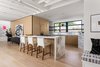 Modern home with Kitchen, Refrigerator, Cooktops, Wall Oven, Dishwasher, Microwave, Marble Counter, Wood Cabinet, Light Hardwood Floor, Marble Backsplashe, Track Lighting, Recessed Lighting, and Undermount Sink. Kitchen from Great Room Photo 7 of Las Casas Residence