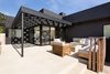 Modern home with Outdoor, Side Yard, Back Yard, Hardscapes, Concrete Patio, Porch, Deck, Wood Patio, Porch, Deck, Decomposed Granite Patio, Porch, Deck, Horizontal Fences, Wall, Small Patio, Porch, Deck, Wood Fences, Wall, and Landscape Lighting. Pergola and gas firepit at rear yard patio Photo 12 of Las Casas Residence