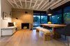 Modern home with Dining Room, Bench, Table, Chair, Storage, Pendant Lighting, Wall Lighting, Accent Lighting, Light Hardwood Floor, Standard Layout Fireplace, and Wood Burning Fireplace. Dining Room with fireplace Photo 17 of Las Casas Residence