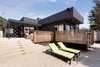 Modern home with Outdoor, Back Yard, Side Yard, Trees, Shrubs, Hardscapes, Walkways, Small Patio, Porch, Deck, Wood Patio, Porch, Deck, Concrete Patio, Porch, Deck, Decomposed Granite Patio, Porch, Deck, Decking Patio, Porch, Deck, Horizontal Fences, Wall, Wood Fences, Wall, and Landscape Lighting. Rear yard steps to firepit with guardrail (swimming pool to right) Photo 11 of Las Casas Residence