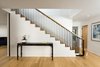 Kitty guards the stair with custom steel guardrail and white oak top rail Photo 16 of Ridgemont Residence modern home