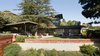 Modern home with Outdoor, Back Yard, Garden, Slope, Woodland, Field, Trees, Shrubs, Hardscapes, Gardens, Grass, Flowers, Raised Planters, Walkways, Hot Tub Pools, Tubs, Shower, Large Patio, Porch, Deck, Wood Patio, Porch, Deck, Decking Patio, Porch, Deck, Stone Patio, Porch, Deck, and Planters Patio, Porch, Deck. Backyard drone photograph Photo 6 of Ridgemont Residence