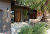 Modern home with Outdoor, Slope, Woodland, Garden, Trees, Flowers, Hardscapes, Gardens, Walkways, Wood Patio, Porch, Deck, Raised Planters, Concrete Patio, Porch, Deck, Stone Patio, Porch, Deck, Planters Patio, Porch, Deck, Horizontal Fences, Wall, Wood Fences, Wall, and Retaining Fences, Wall. Front yard entry with custom American Black Walnut door by Quantum Windows & Doors Photo 17 of Ridgemont Residence