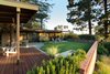 Modern home with Outdoor, Back Yard, Garden, Field, Slope, Woodland, Trees, Shrubs, Grass, Hardscapes, Stone Patio, Porch, Deck, Gardens, Flowers, Walkways, Wood Patio, Porch, Deck, Pavers Patio, Porch, Deck, Decking Patio, Porch, Deck, Planters Patio, Porch, Deck, Horizontal Fences, Wall, and Retaining Fences, Wall. Backyard at deck, pergola and fountain Photo 9 of Ridgemont Residence