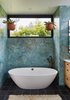 Modern home with Bath Room, Marble Wall, Freestanding Tub, Engineered Quartz Counter, Recessed Lighting, Undermount Sink, One Piece Toilet, Cement Tile Floor, and Corner Shower. Privacy and natural light: Hanging plants in the bathroom with clerestory windows framing the neighborhood tree canopies beyond. Blue marble, black Cle cement floor tiles, white oak cabinetry and white mosaic tile backsplash are complimented with French Bronze plumbing fixtures from Rohl. Photo 7 of Ashland Residence