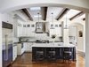 Modern home with Kitchen, Marble Counter, White Cabinet, Medium Hardwood Floor, Stone Tile Backsplashe, Glass Tile Backsplashe, Pendant Lighting, Recessed Lighting, Refrigerator, Dishwasher, Range, Range Hood, Microwave, Ice Maker, Wine Cooler, and Undermount Sink. Kitchen remodel Photo of Rustic elegance