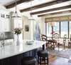 Modern home with Kitchen, Marble Counter, Wood Cabinet, White Cabinet, Colorful Cabinet, Medium Hardwood Floor, Stone Tile Backsplashe, Glass Tile Backsplashe, Recessed Lighting, Undermount Sink, and Pendant Lighting. Kitchen remodel Photo 2 of Rustic elegance