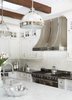 Modern home with Kitchen, Marble Counter, White Cabinet, Medium Hardwood Floor, Stone Tile Backsplashe, Pendant Lighting, Range, Range Hood, Glass Tile Backsplashe, Recessed Lighting, and Undermount Sink. Kitchen remodel Photo 3 of Rustic elegance