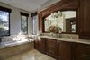 Modern home with Bath Room, Stone Counter, Travertine Floor, Undermount Sink, Soaking Tub, Recessed Lighting, Accent Lighting, Enclosed Shower, Stone Tile Wall, Wall Lighting, and One Piece Toilet. Master Bath Remodel Photo 11 of Rustic elegance
