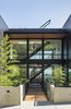 Modern home with Outdoor, Front Yard, Shrubs, Grass, Trees, Hardscapes, and Small Patio, Porch, Deck. Entry Bridge Photo 2 of Music Box Residence