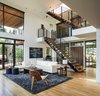 Modern home with Living Room, Chair, Coffee Tables, End Tables, Medium Hardwood Floor, Lamps, Ceiling Lighting, Recessed Lighting, Rug Floor, and Sectional. Interior Photo 3 of Music Box Residence