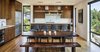 Modern home with Kitchen, Wood Cabinet, Refrigerator, Medium Hardwood Floor, Ceiling Lighting, Pendant Lighting, Undermount Sink, and Range. Kitchen Photo 4 of Music Box Residence