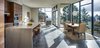 Modern home with Wood Cabinet, Ceramic Tile Floor, Granite Counter, Ceramic Tile Backsplashe, Wall Oven, Ceiling Lighting, Cooktops, Range Hood, Range, Microwave, Chair, Sofa, Dining Room, Table, and Stools. Kitchen/Living/Dining Photo 5 of Canterbury Residence