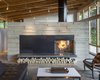 Modern home with Living Room, Ceiling Lighting, Coffee Tables, Sofa, Concrete Floor, and Two-Sided Fireplace. Fire Place Photo 4 of Brightwood Cabin