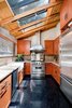 Modern home with Kitchen, Granite Counter, Wood Cabinet, Refrigerator, Track Lighting, Dark Hardwood Floor, and Dishwasher. Kitchen Photo 10 of Cedar Lodge on over a 1/2 Private Acre in Lower Nichols Canyon
