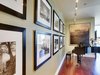 John is an avid world traveler and photographer. He took these photos (left) on one of his journeys to Thailand. We had them framed and hung in this bold arrangement. The Galen Garwood painting at the end of the hall was from their previous home. Originally, its frame was painted a light mauve, reminiscent of the 80s, so we chose to re-paint the frame an espresso/black. The small change brought the whole piece up-to-date. Photo 14 of Downsize Upstyle modern home