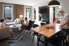 Modern home with Chair, Table, Pendant Lighting, Track Lighting, Rug Floor, Ribbon Fireplace, Living Room, Coffee Tables, Shelves, Sofa, and Concrete Floor. The ToDD Residence Photo 11 of The ToDD Residence