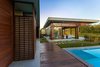 Modern home with Outdoor, Swimming Pools, Tubs, Shower, Shrubs, Front Yard, Trees, Grass, Hardscapes, and Decking Patio, Porch, Deck. View of the two bays along with the swimming pool. Photo 4 of The Open house