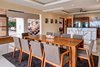 Modern home with Dining Room, Ceiling Lighting, and Porcelain Tile Floor. Dining room, kitchen, entrance hall and living area Photo 9 of Pacific Breeze house overlooking the Ocean