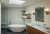 Modern home with Bath Room, Marble Counter, Undermount Sink, Porcelain Tile Floor, Freestanding Tub, Open Shower, Recessed Lighting, Wall Lighting, and Ceramic Tile Wall. Master bathroom with carrara counters and quarter sawn walnut cabinets. Photo 11 of Mt. Tabor