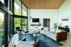 Modern home with Living Room, Coffee Tables, Chair, Sofa, Ottomans, Console Tables, Lamps, Recessed Lighting, Floor Lighting, Light Hardwood Floor, and Two-Sided Fireplace. Living room looking toward entry. Photo 5 of Mt. Tabor