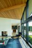 Modern home with Living Room, Two-Sided Fireplace, Light Hardwood Floor, Recessed Lighting, Chair, Ottomans, and Floor Lighting. Original double sided fireplace wrapped in smooth plaster. Photo 6 of Mt. Tabor