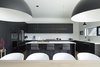 Modern home with Kitchen, Range Hood, Ceramic Tile Backsplashe, Pendant Lighting, Refrigerator, Engineered Quartz Counter, Ceiling Lighting, Recessed Lighting, Wall Oven, Microwave, Dishwasher, Laminate Cabinet, and Cooktops. Kitchen Photo 6 of Riverwood