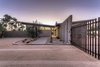 Modern home with Exterior, House Building Type, Concrete Siding Material, Butterfly RoofLine, and Metal Roof Material. Front entry of home. The low point of the butterfly roof is centered over the front entry door. An
exposed beam connects the roof and creates an organizing element inside and outside the home. Photo of Arroyo House