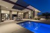 Modern home with Outdoor, Vertical Fences, Wall, Hardscapes, Swimming Pools, Tubs, Shower, Pavers Patio, Porch, Deck, Metal Fences, Wall, Desert, and Concrete Patio, Porch, Deck. A steel trellis is integrated into the roof at the main patio to bring light and shadows to the outdoor
living space below while still protecting from intense sun. Photo 2 of Arroyo House