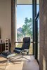Modern home with Living Room, Chair, and Light Hardwood Floor. The corner window at the reading area floods the space with natural light and provides beautiful views to Camelback Mountain. Photo 6 of Arroyo House