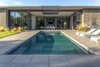 Modern home with Outdoor, Back Yard, Metal Patio, Porch, Deck, Desert, and Swimming Pools, Tubs, Shower. Pool centered on outdoor living space and central fireplace beyond. Photo 8 of Arroyo House