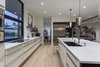 Modern home with Pendant Lighting, Light Hardwood Floor, and Recessed Lighting. The combination of white and dark wood cabinets give the kitchen a modern but classic feel. Photo 12 of Arroyo House