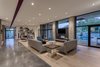 Modern home with Living Room, Concrete Floor, Recessed Lighting, Light Hardwood Floor, and Chair. The main living area provides an open living concept and views to the mountains beyond. Photo 13 of Arroyo House