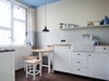 Modern home with Kitchen, Laminate Counter, White Cabinet, Wood Cabinet, Concrete Floor, Table Lighting, Pendant Lighting, Track Lighting, Accent Lighting, Refrigerator, Cooktops, and Dishwasher. kitchen, based on original designs by Bruno Taut, around 1927 Photo 4 of Taut´s Home (Tautes Heim) - Rentable museum of design and architecture of the 1920s