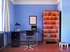 Modern home with Office, Study Room Type, Lamps, Chair, Desk, and Medium Hardwood Floor. writing desk with portrait of Bruno Taut and typical tiled stove Photo 11 of Taut´s Home (Tautes Heim) - Rentable museum of design and architecture of the 1920s
