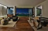 Modern home with Dark Hardwood Floor, Large Pools, Tubs, Shower, Swimming Pools, Tubs, Shower, and Doors. Sliding glass doors open up the house, offering sweeping views from the Pacific Ocean to downtown Los Angeles. Photo 13 of Trousdale Place Residence
