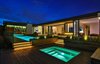 Modern home with Back Yard, Large Pools, Tubs, Shower, Swimming Pools, Tubs, Shower, Hardscapes, Grass, Trees, Shrubs, Large Patio, Porch, Deck, Decking Patio, Porch, Deck, Wood Patio, Porch, Deck, Landscape Lighting, House Building Type, Metal Roof Material, Wood Siding Material, Living Room Room Type, and Living Space Room Type. The hardscape design extends the interior spaces into the back yard while maximizing the views from both inside and outside the home
Photo 18 of Trousdale Place Residence