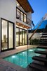 Offering plenty of privacy a courtyard pool is flanked by planted garden spaces which surround the home. Photo 16 of Milwood Residence modern home