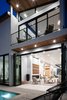 Modern home with Exterior, Flat RoofLine, Shed RoofLine, Shingles Roof Material, House Building Type, and Stucco Siding Material. Sliding glass doors are used to connect the living spaces with the backyard, garage, and detached accessory space. Photo 17 of Milwood Residence