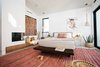 Modern home with Rug Floor, Porcelain Tile Floor, Recessed Lighting, and Pendant Lighting. Fireplace in the master bedroom offers a cozy respite for its occupants during winter. Photo 13 of Milwood Residence