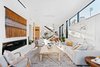 Modern home with Living Room, Recessed Lighting, Coffee Tables, Chair, Porcelain Tile Floor, Sofa, and Gas Burning Fireplace. The open floor plan which blends living and dining spaces makes the home ideal for family or friendly gatherings. Photo 10 of Milwood Residence