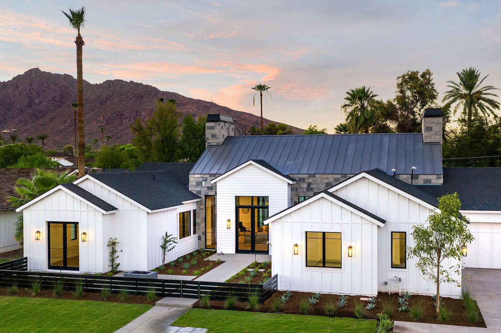 This modern farmhouse's enviable location includes views of iconic Camelback Mountain, lush landscaping, and a neighborhood teeming with families.  