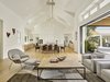 Modern home with Kitchen, Engineered Quartz Counter, Stone Slab Backsplashe, Pendant Lighting, Refrigerator, Light Hardwood Floor, White Cabinet, Wall Oven, Cooktops, Range, Drop In Sink, and Wine Cooler. Wood meet concrete. Continuous living. Photo 2 of Wine Country Cool