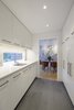 Modern home with Kitchen, White Cabinet, Concrete Counter, Ceiling Lighting, Slate Floor, and Subway Tile Backsplashe. New butler's pantry with slate floors and high-gloss cabinets. Photo of Professors Row