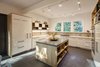 Modern home with Kitchen, Concrete Counter, White Cabinet, Slate Floor, Wood Cabinet, Ceiling Lighting, Wall Oven, and Track Lighting. New custom kitchen with high-gloss cabinets, custom plywood enclosures, concrete island counter top. Photo 2 of Professors Row