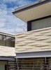 Modern home with Exterior, Stone Siding Material, and House Building Type. Tapered stone cladding creates a weaving effect on the façade of the house and its appearance changes throughout the day as the sun creates continuously shifting shadow patterns. Photo 6 of LAKE AUSTIN HOUSE