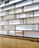 Modern home with Dining Room and Shelves. A combination of clear and translucent glass on steel shelves. Photo of LAKE AUSTIN HOUSE