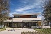 Modern home with Exterior, House Building Type, and Stone Siding Material. Local limestone, ample daylighting, natural ventilation and deep overhangs serve to connect the house to its context through its materiality and ease of opening up the exterior. Photo 9 of LAKE AUSTIN HOUSE