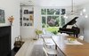 Modern home with Dining Room, Chair, Shelves, Table, Standard Layout Fireplace, and Pendant Lighting. The "sculptural" kitchen was replaced with a new open-plan cooking space, where concrete countertops are paired with glossy white cabinets and large windows frame views of the landscape. Photo 2 of Modern Barns